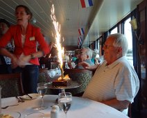 B00_Rhapsody20_KennsBirthday Kenn gets help celebrating a birthday in the dining room of the Rhapsody. The lovely Dutch lass, Petra, was the tour guide for our group of 40. OIutstanding...