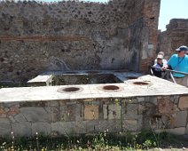 An excavated shop in Pompsii. The jars held different kinds of oil. A couple guys from our group, Jeff and John, are trailing us. An excavated shop in Pompsii. The jars held different kinds of oil. A couple guys from our group, Jeff and John, are trailing us.