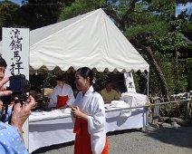 Joyce takes a picture of a Miko, or "shrine virgin." Their role in contemporary Shintō has been much depreciated -- their main tasks today are mostly to assist the male priests, clean the shrine compound, sell amulets at the shrine shop, perform dances, and assist in shrine rituals and prayers. At he Kenchoji shrine in Kamakura. Joyce takes a picture of a Miko, or "shrine virgin." Their role in contemporary Shintō has been much depreciated -- their main tasks today are mostly to assist...