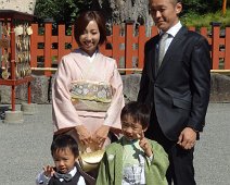 Young Japanese couple taking their two young sons to the shrine for Shichi-go-san, a day of prayer for the healthy growth of young children. Boys and girls aged three, boys aged five, and girls aged seven visit a Shinto shrine with their parents. Young Japanese couple taking their two young sons to the shrine for Shichi-go-san, a day of prayer for the healthy growth of young children. Boys and girls aged...