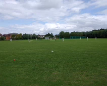 A game of cricket. A one-day test match on the field adjacent to the Tewksbury Abbey.
