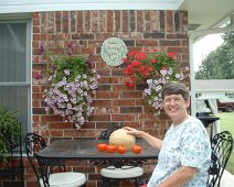 GardenPlace_SylviaMelons2 Sylvia admires cantalope and tomatoes at our house on Garden Place in Bentonville.